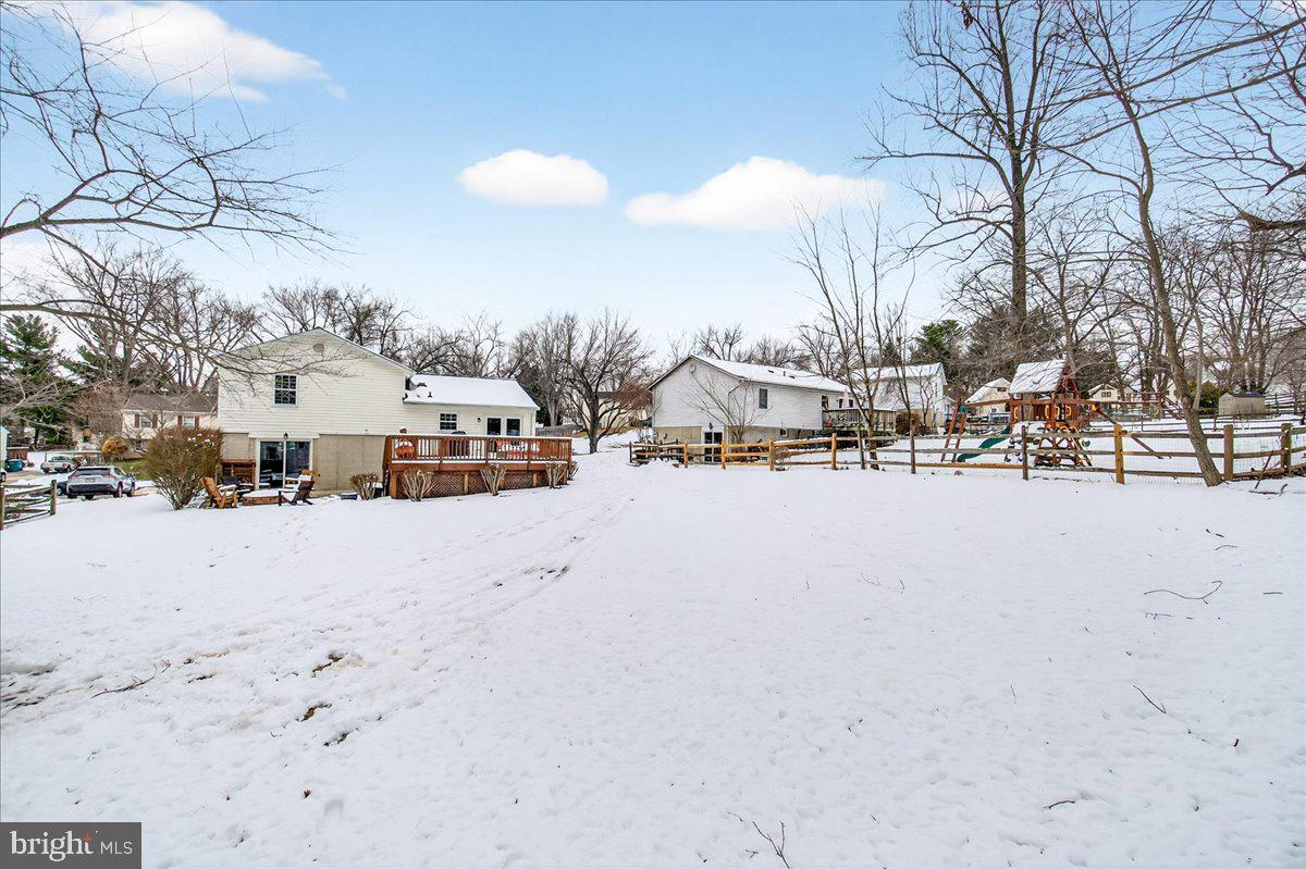 24013 Bush Hill Road Gaithersburg, MD 20882 - Photo 35 of 38 a view of city street and snow on the road