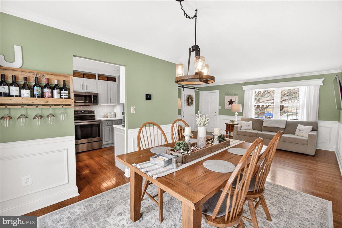 24013 Bush Hill Road Gaithersburg, MD 20882 - Photo 10 of 38 a view of a dining room with furniture window and wooden floor