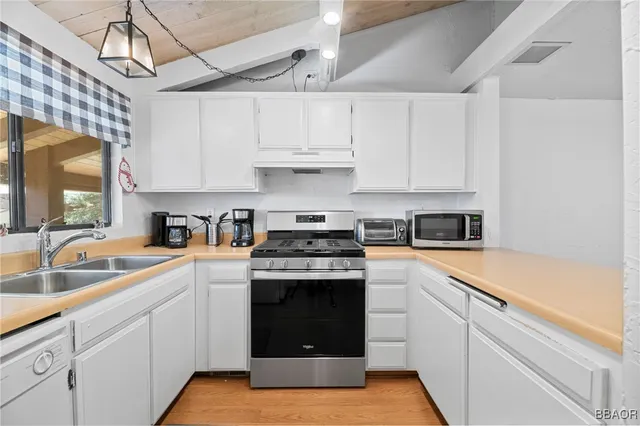 a kitchen with a sink and a refrigerator