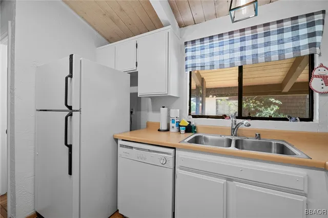 a kitchen with a refrigerator and a sink