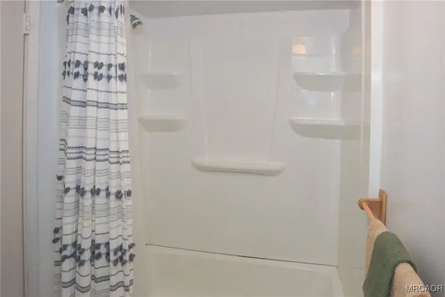 a large bed sitting in a bedroom next to a window