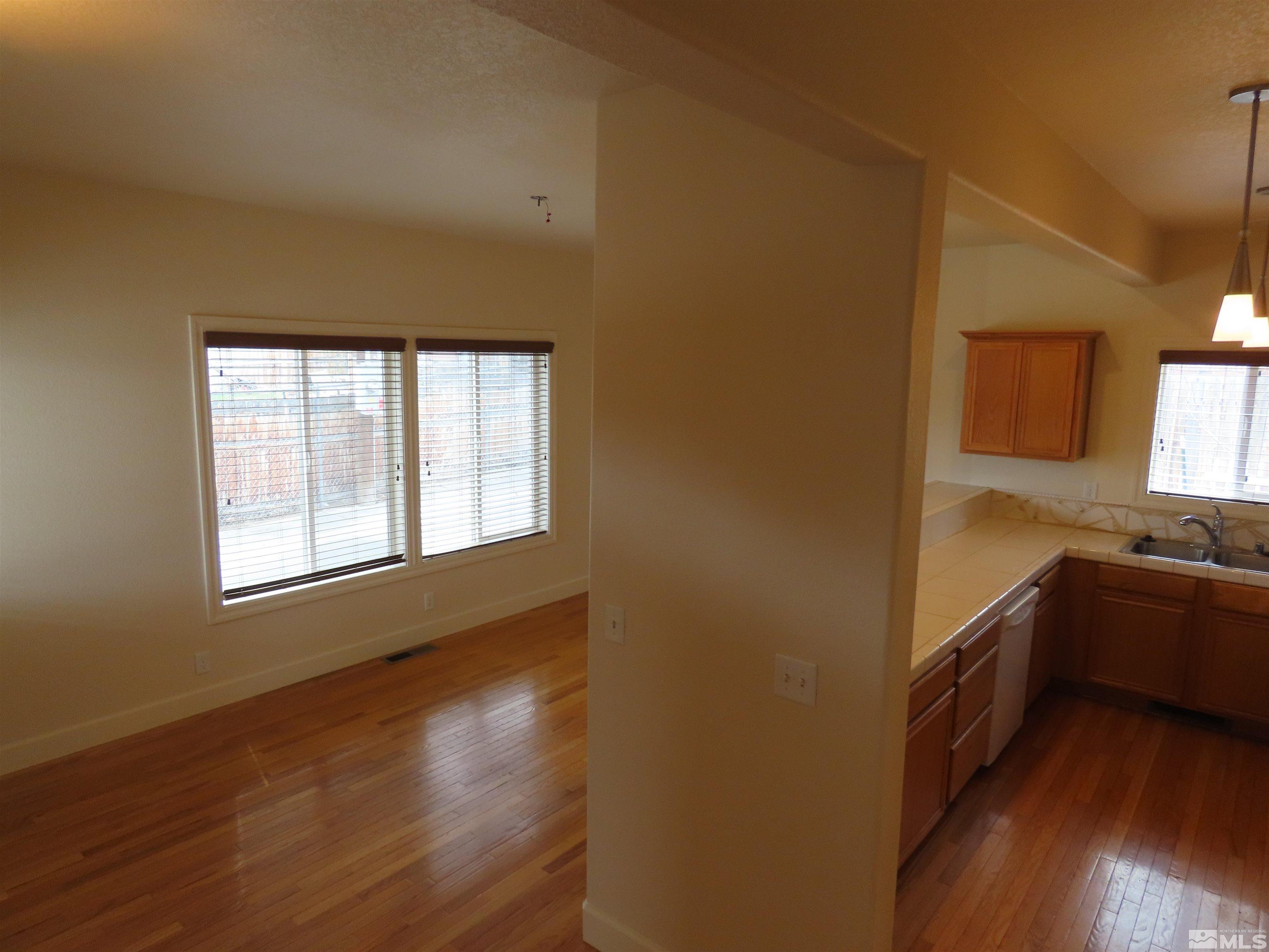 1222 Lander Street Reno, NV 89509 - Photo 4 of 18 a kitchen with a sink and wooden floor