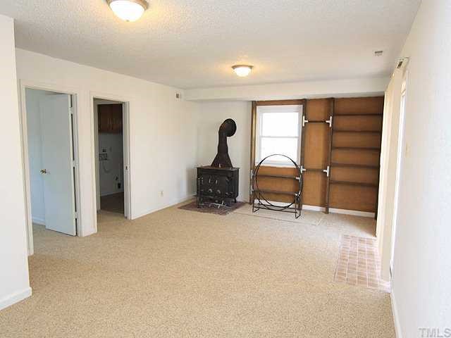 530 Andover Road Durham, NC 27712 - Photo 7 of 12 an empty room with furniture and a window