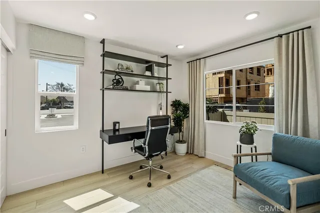 a view of a livingroom with workspace and a window