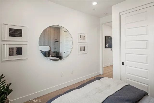 a bedroom with a bed and a mirror