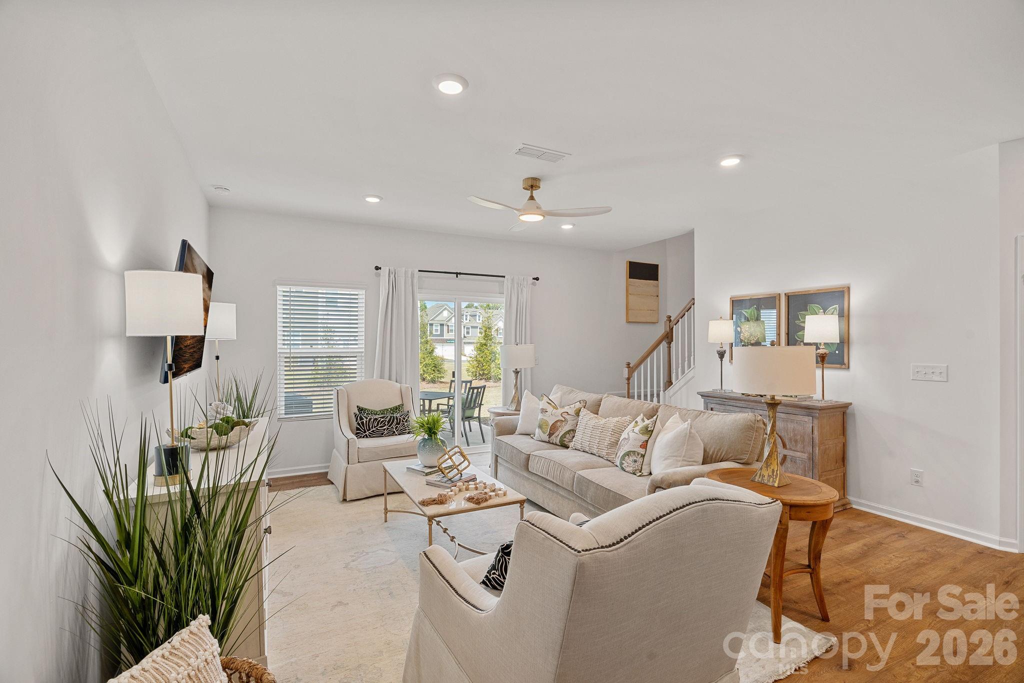 3579 Nimbell Road Monroe, NC 28110 - Photo 11 of 24 a living room with furniture a wooden floor and a lamp