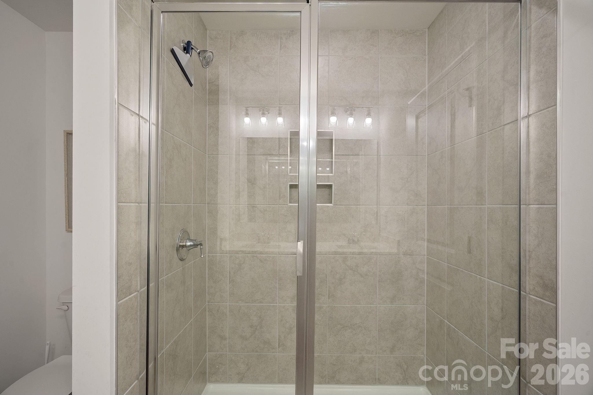 3579 Nimbell Road Monroe, NC 28110 - Photo 16 of 24 a bathroom with a glass shower door