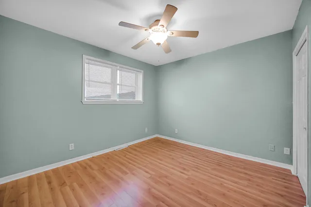 wooden floor in an empty room with a window