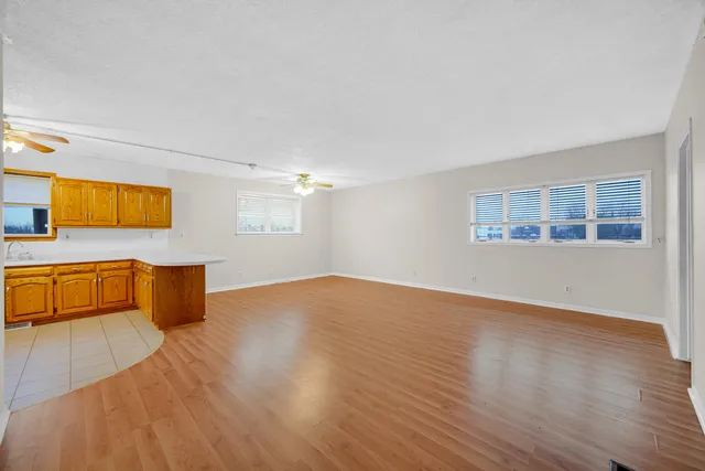 a view of a kitchen with kitchen island and wooden floor