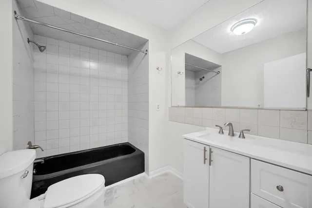 a bathroom with a sink a toilet and bathtub