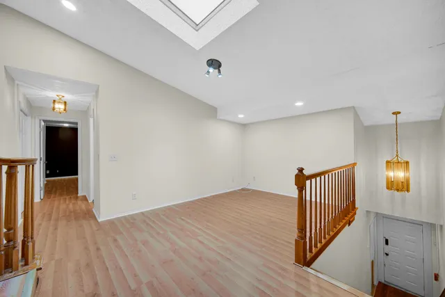 a view of a hallway with wooden floor