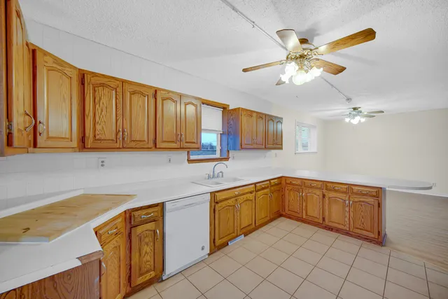 a kitchen with a sink cabinets and window