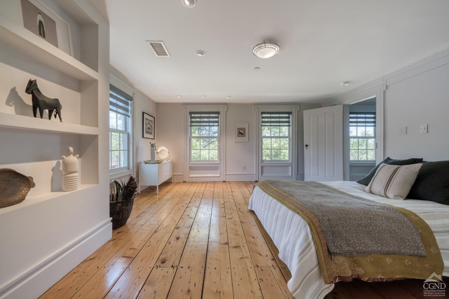 261 Kipp Road Hudson, NY 12534 - Photo 13 of 36 a spacious bedroom with a bed and wooden floor