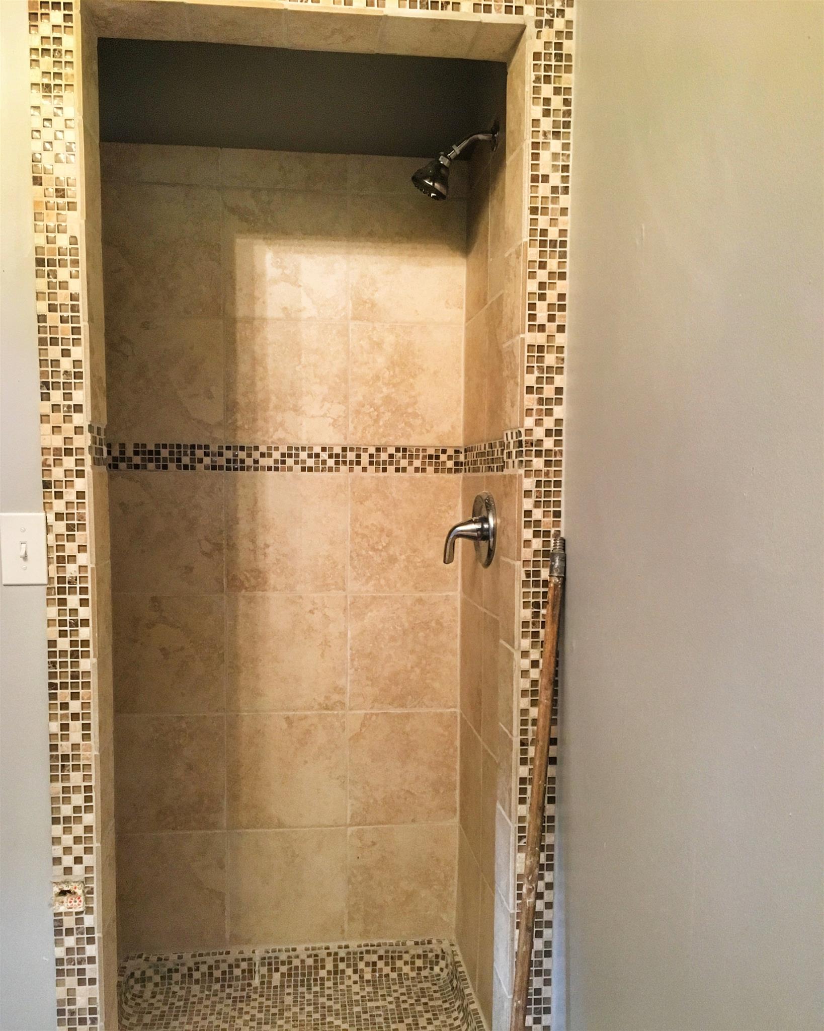 1526 Murfreesboro Road Lebanon, TN 37090 - Photo 10 of 11 The master bath features a modern tile shower, complete with accent tiles.
