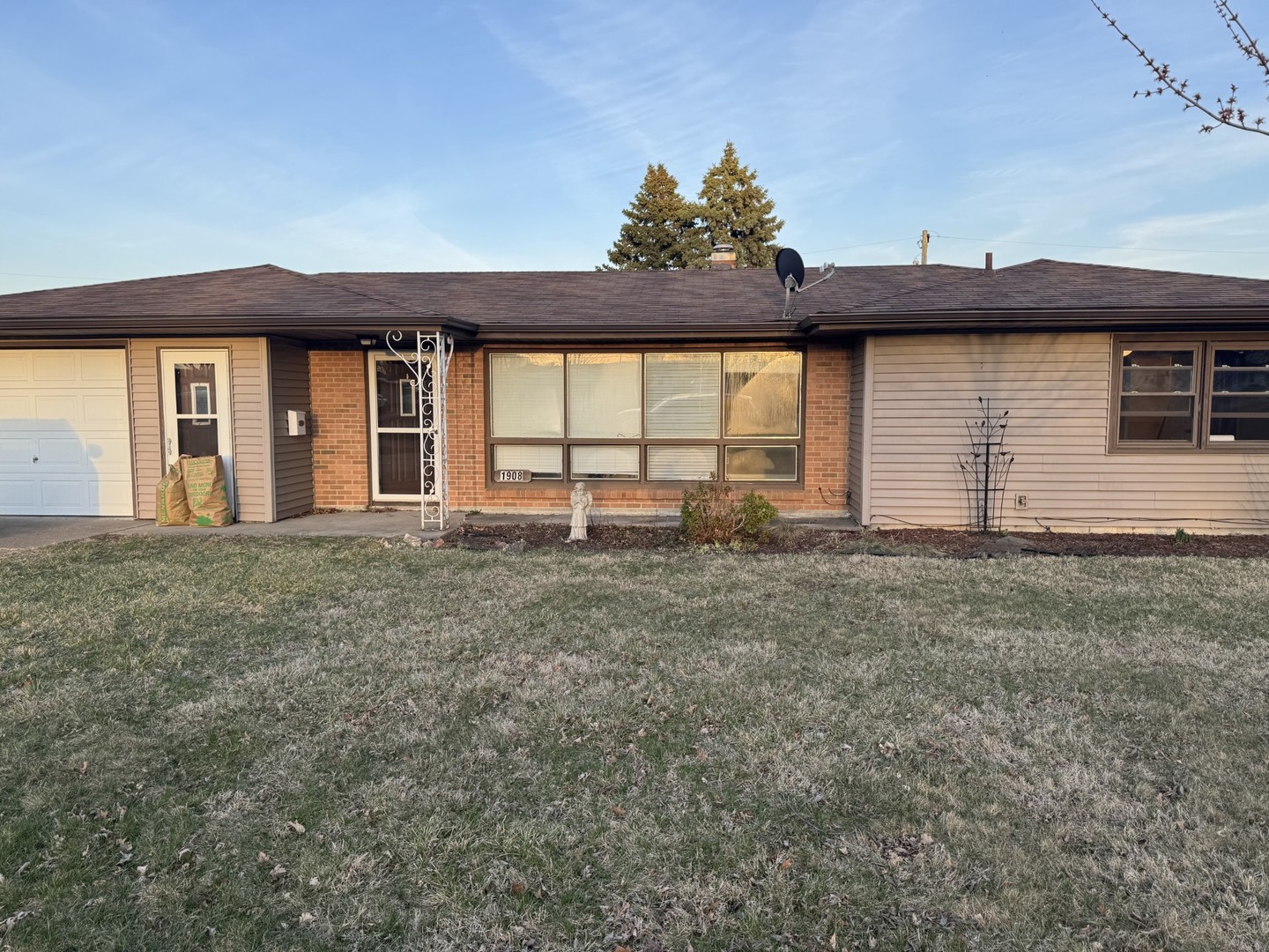 a view of a house with a yard and garage