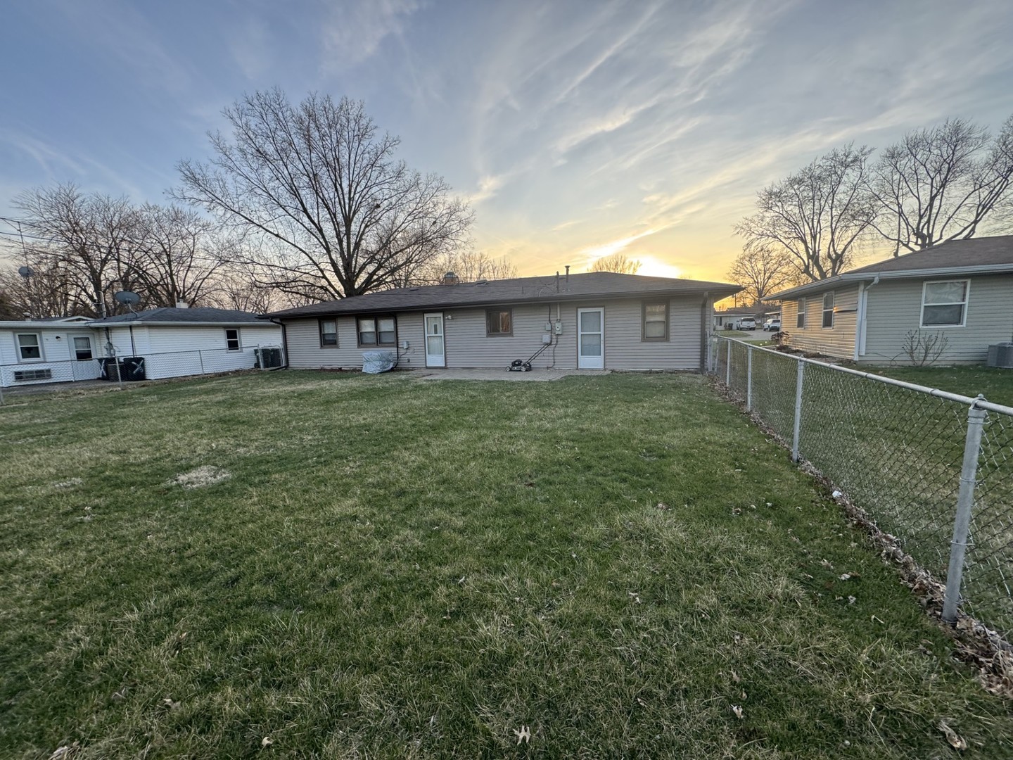 1908 22nd Avenue Sterling, IL 61081 - Photo 6 of 11 a view of a house with a big yard and large trees