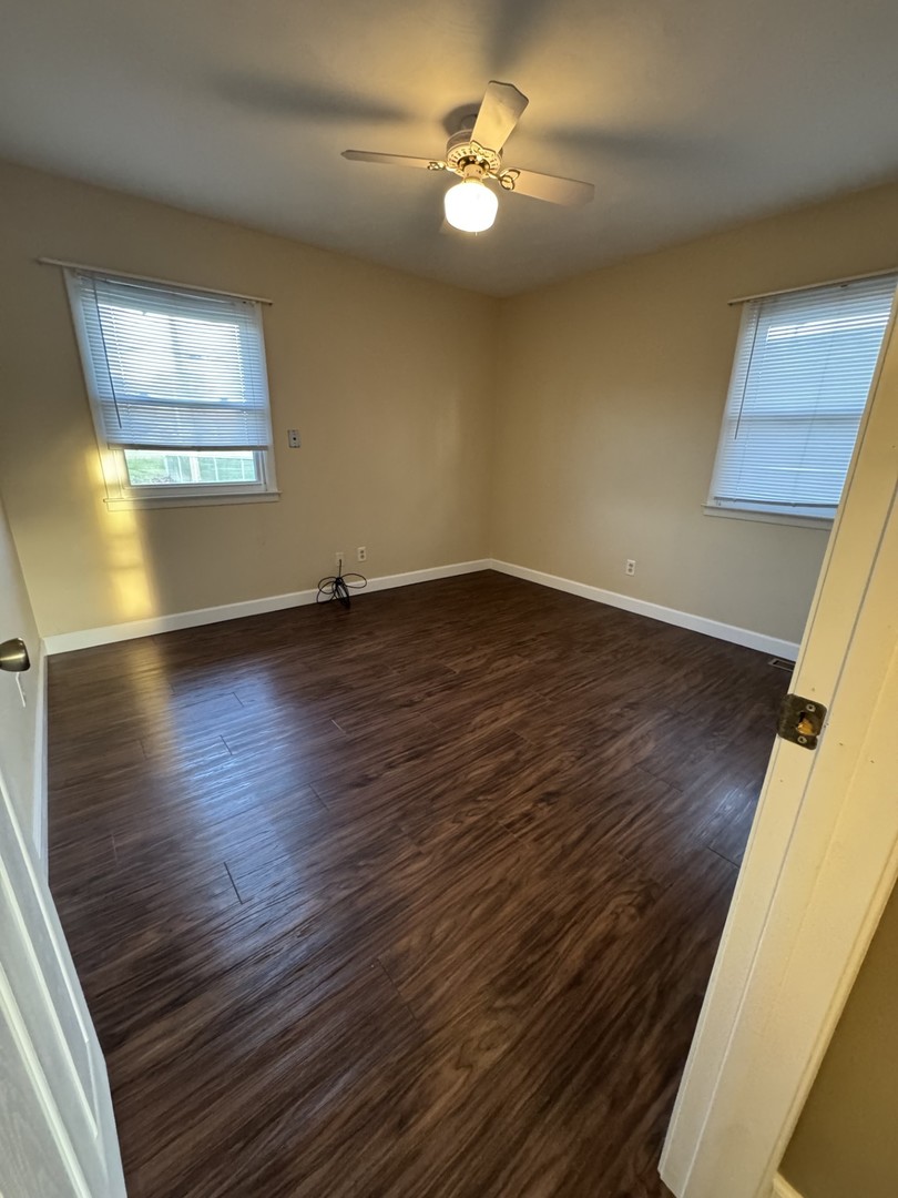 1908 22nd Avenue Sterling, IL 61081 - Photo 9 of 11 a view of an empty room with wooden floor and a window