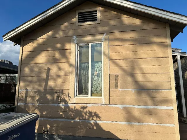 a front view of a house with parking area