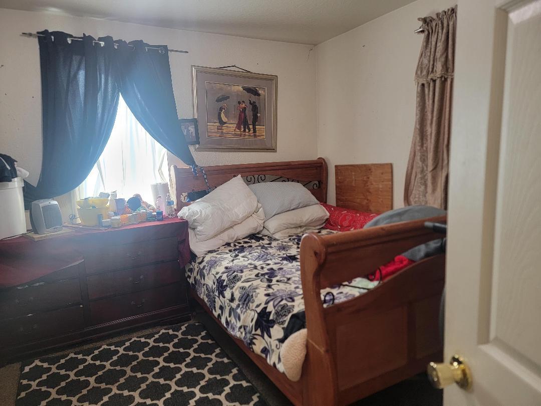 148 E Street Fresno, CA 93706 - Photo 13 of 13 a bed sitting in a bedroom next to a window