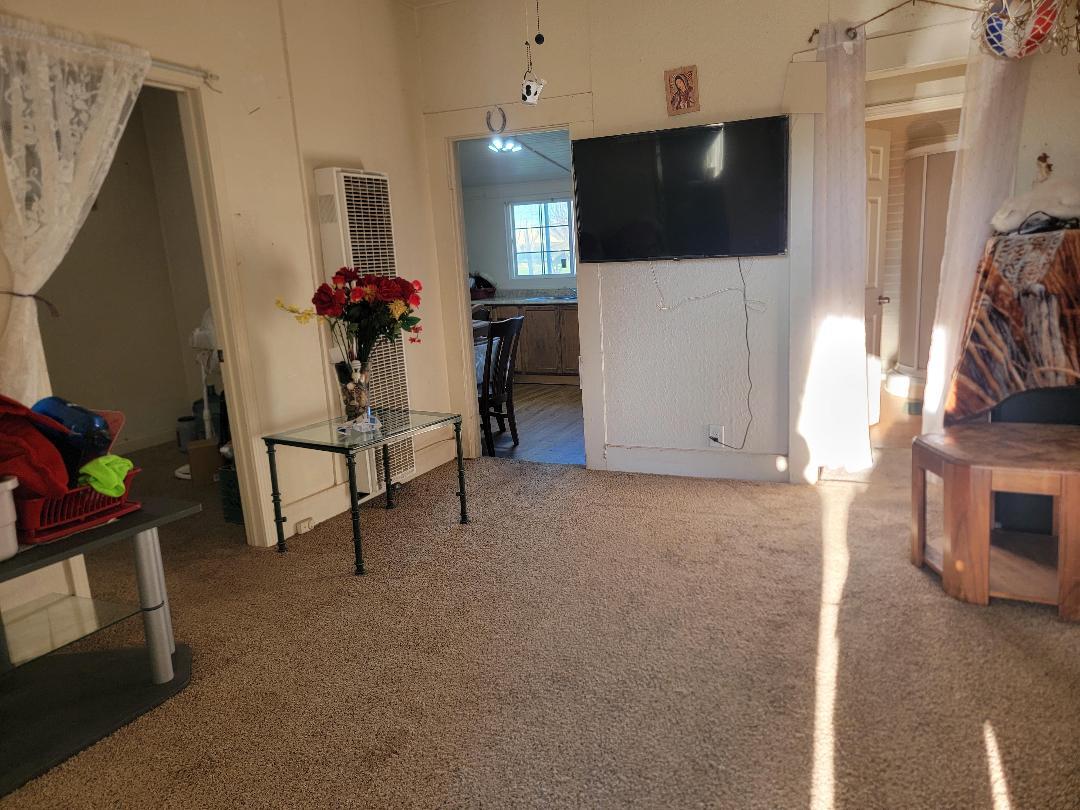 148 E Street Fresno, CA 93706 - Photo 3 of 13 a living room with furniture and a flat screen tv