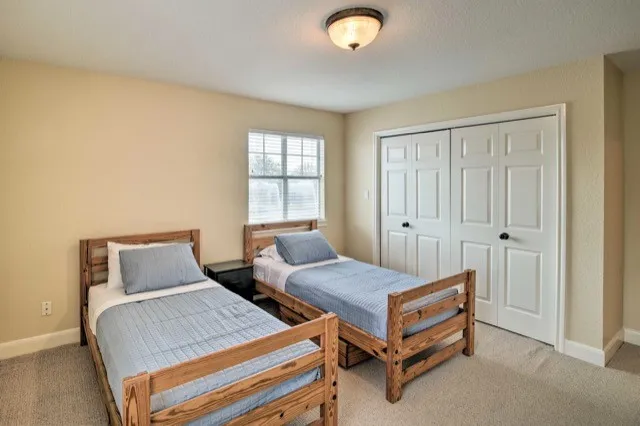 a bedroom with two beds and a window