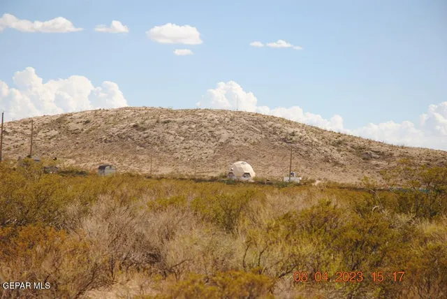 a view of a dry yard and mountain view