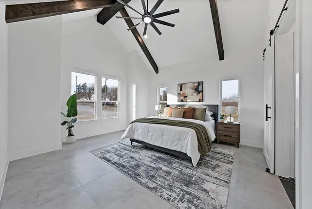 a bedroom with a bed and a refrigerator