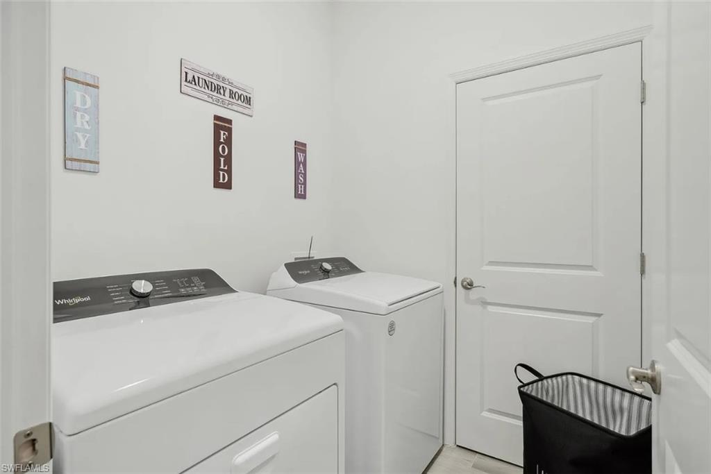 3122 Juniper Way Naples, FL 34112 - Photo 14 of 28 a utility room with dryer and washer