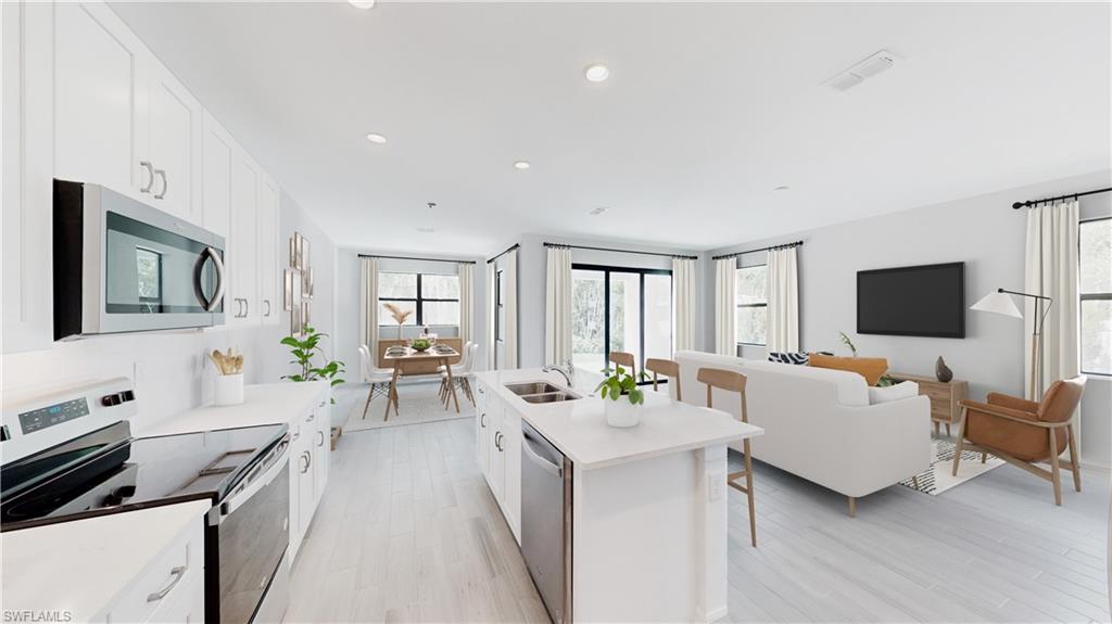 3122 Juniper Way Naples, FL 34112 - Photo 3 of 28 a living room with furniture and a flat screen tv