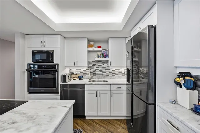 a kitchen with a refrigerator and a sink