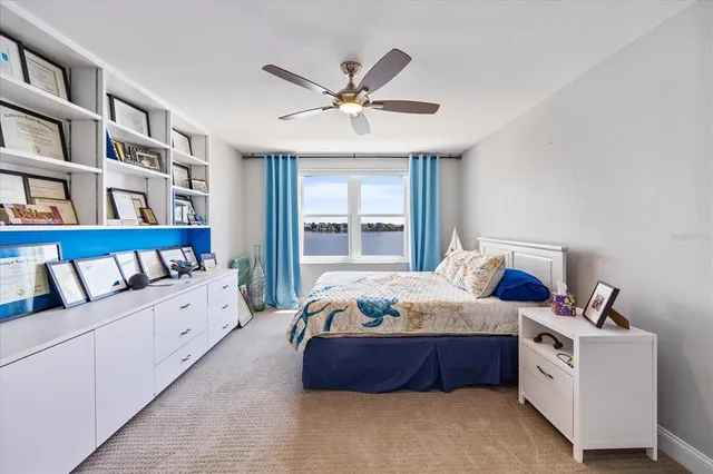 a bedroom with a large bed and a chandelier