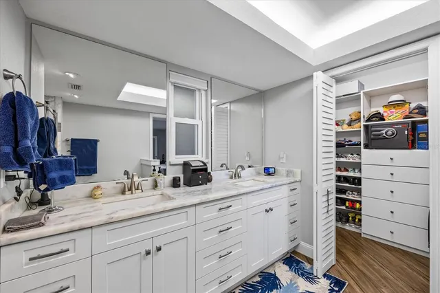 a view of walk in closet with clothes