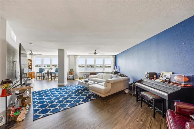 a living room with furniture and a wooden floor
