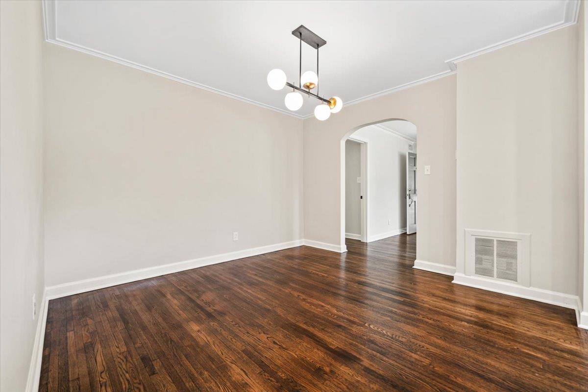 170 South Greer Street Memphis, TN 38111 - Photo 21 of 35 Spacious room featuring dark wood-finish flooring, light neutral-toned walls, and a modern ceiling light fixture