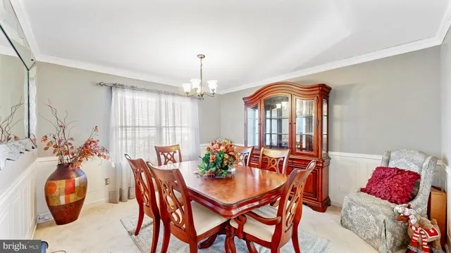a view of a dining room with furniture and chandelier