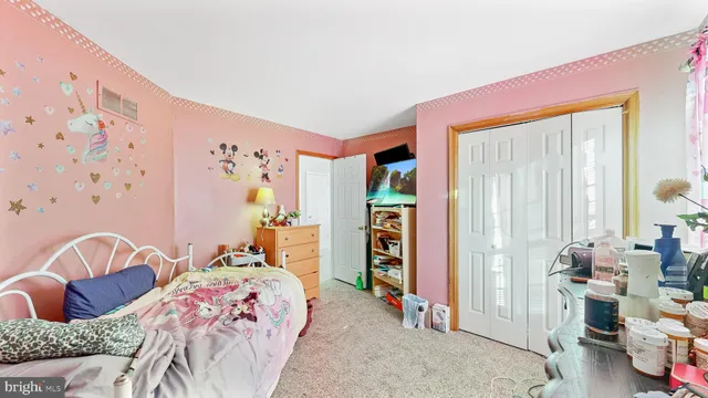 a bedroom with bed and a window