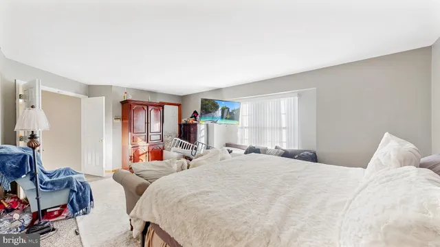 a bathroom with a tub a sink and a large mirror