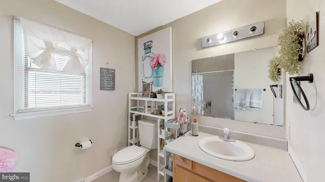 a bathroom with a sink and wooden floor