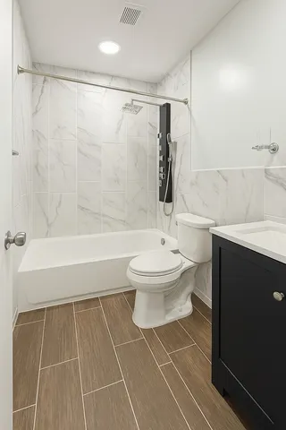 a bathroom with a toilet a sink and shower