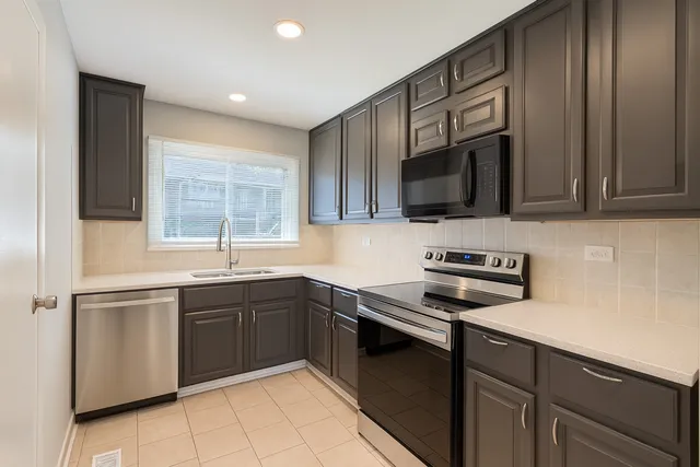 a kitchen with a sink stove and microwave