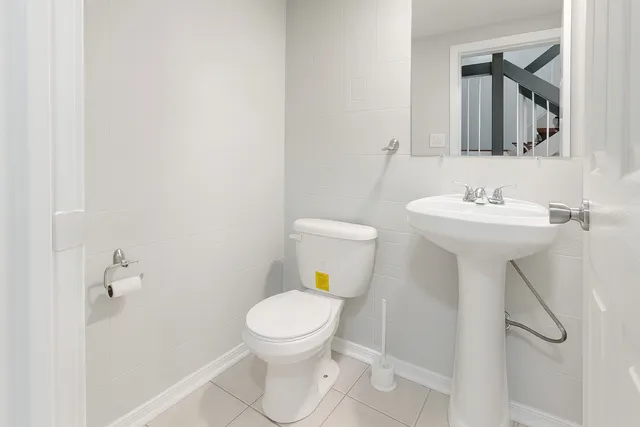 a bathroom with a sink toilet and a mirror
