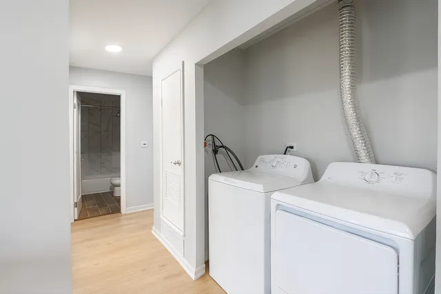 a view of storage and utility room with washer and dryer