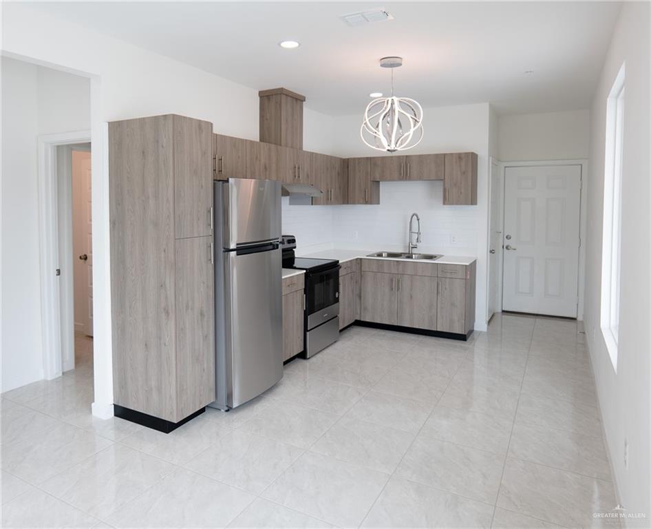 5325 Vision Street, Unit A Rio Grande City, TX 78582 - Photo 4 of 8 a kitchen with refrigerator and window