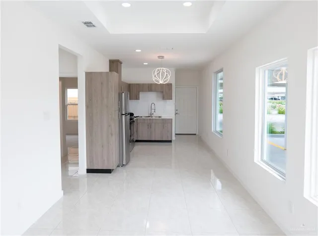a view of kitchen with refrigerator and window