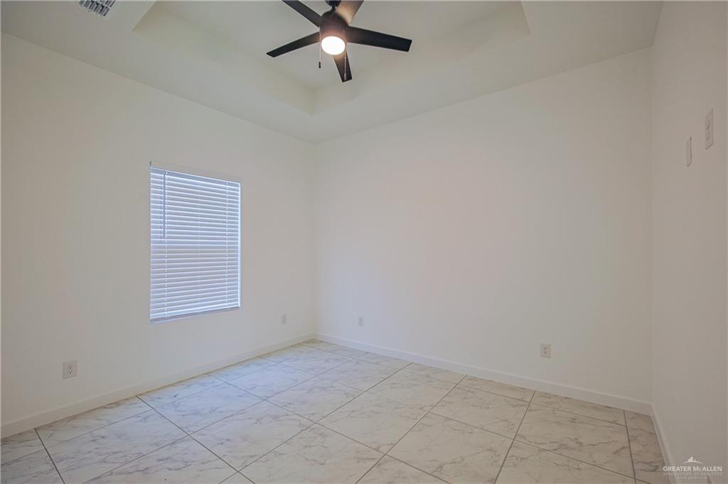 5325 Vision Street, Unit A Rio Grande City, TX 78582 - Photo 6 of 8 an empty room with windows