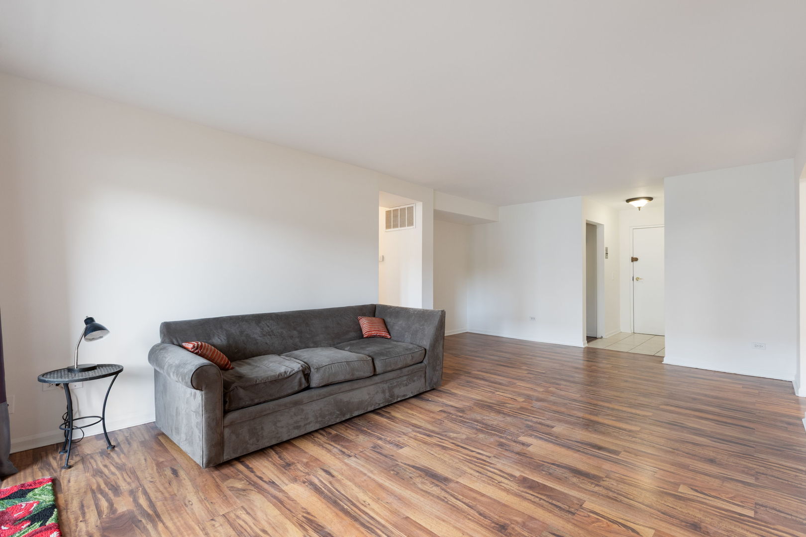 435 Ridge Road, Unit 108 Wilmette, IL 60091 - Photo 3 of 18 a living room with furniture and a wooden floor