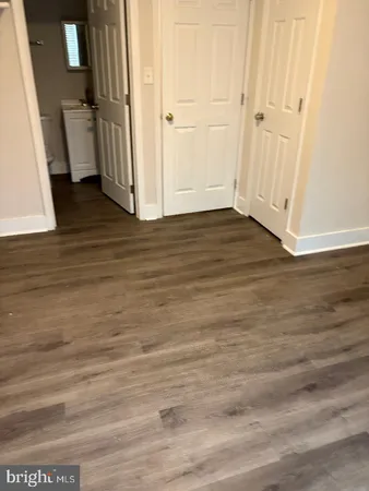 a view of a room with wooden floor
