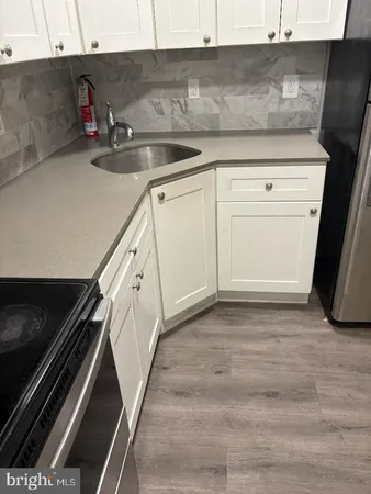 a kitchen with granite countertop a stove and a microwave