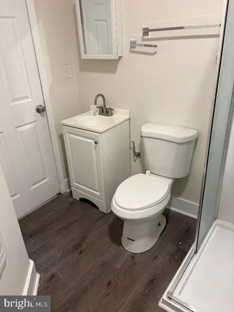 a white toilet sitting next to a bathroom