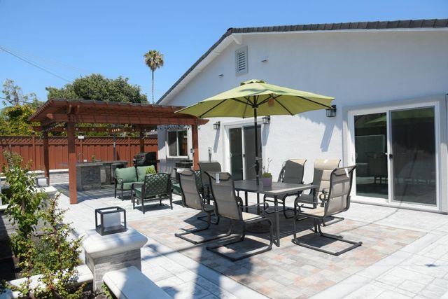 a view of a chairs and table in the balcony